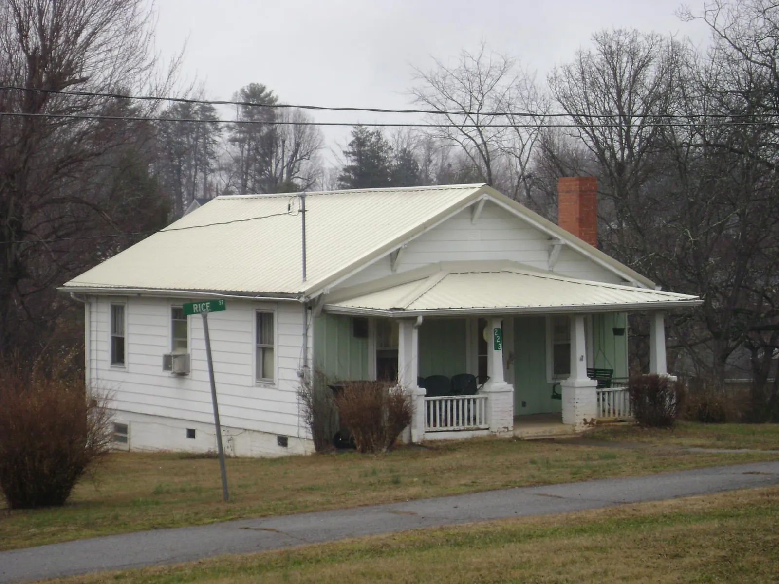 White metal roof on a craftsman bungalow at a street corner in Lexington